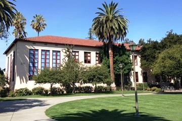 Large building Bergin Hall surrounded by trees and greenery.