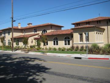 A beige building titled Jesuit Residence with a red-tiled roof.