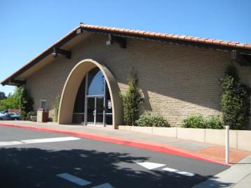 A beige building with an arched entrance at 990 Benton.