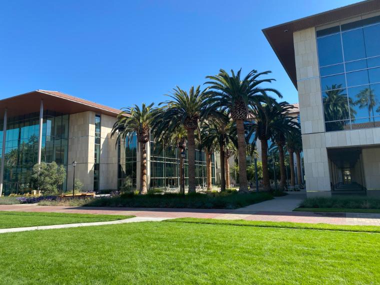 Sobrato Campus for Discovery and Innovation building with green lawn and trees.