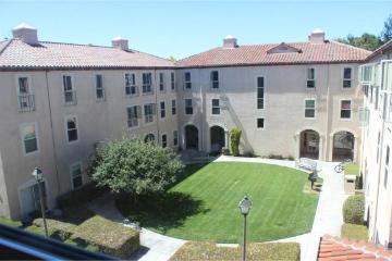University Villas courtyard with greenery and surrounding multi-story buildings.